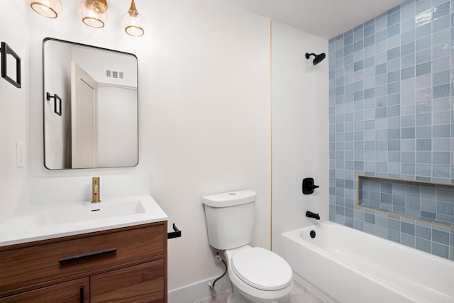 full bathroom with vanity, tiled shower / bath combo, and toilet