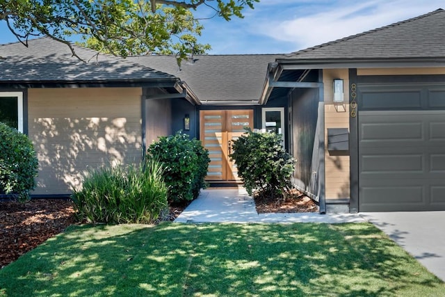 view of front of house with a front yard and a garage