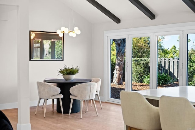 dining room featuring a notable chandelier, light hardwood / wood-style floors, and vaulted ceiling with beams