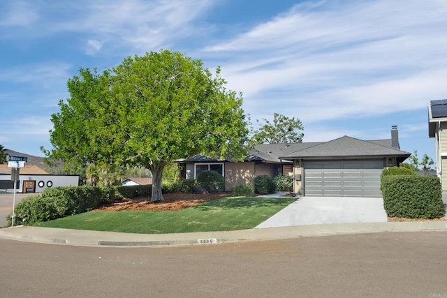 view of front facade with a front yard and a garage