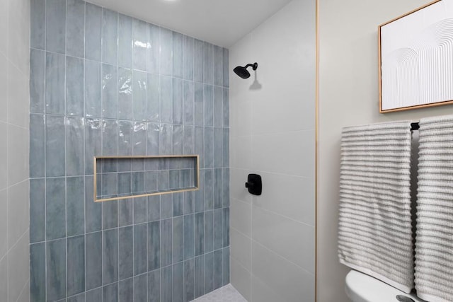 bathroom with a tile shower