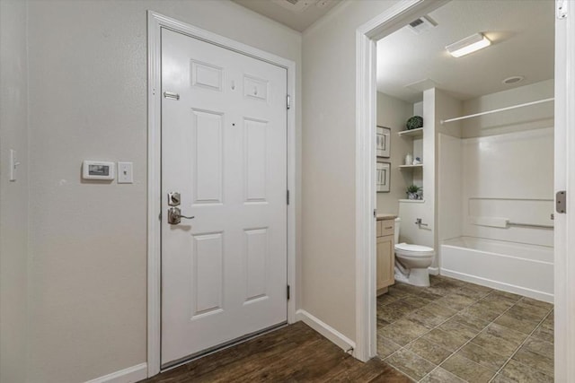 interior space featuring toilet, shower / tub combination, and vanity