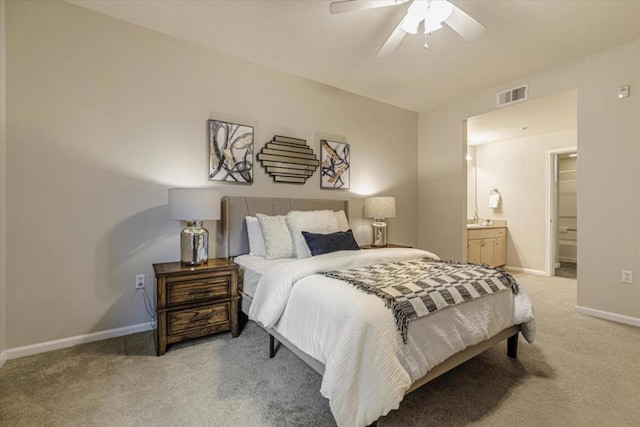 carpeted bedroom with ceiling fan, connected bathroom, and sink