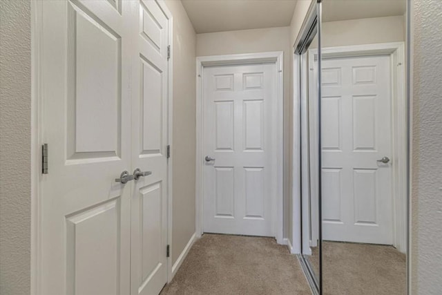 corridor with light colored carpet