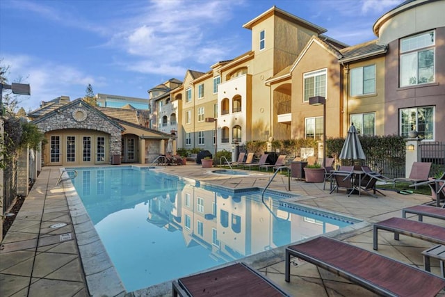 view of pool with a patio area and a hot tub