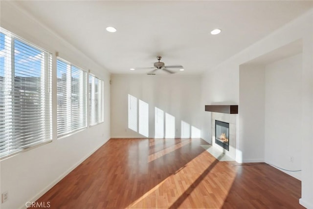 unfurnished living room featuring ceiling fan and wood-type flooring