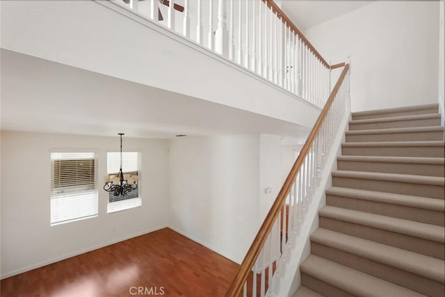 stairway featuring a chandelier and hardwood / wood-style floors