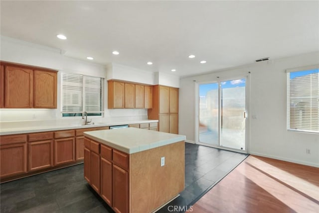 kitchen featuring dark hardwood / wood-style floors, sink, crown molding, and a kitchen island