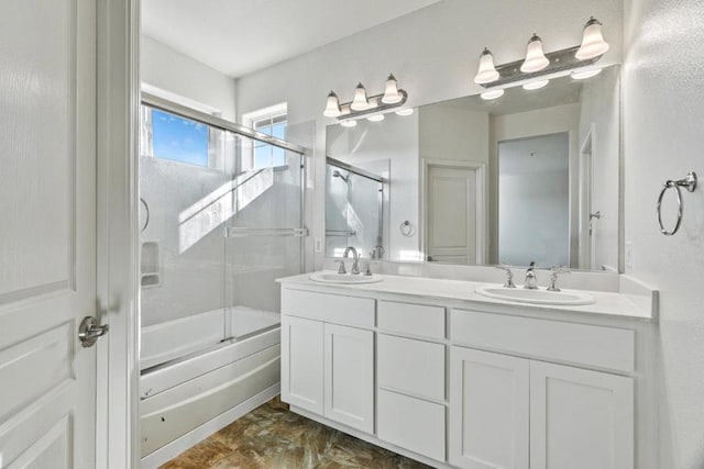 bathroom with vanity and bath / shower combo with glass door