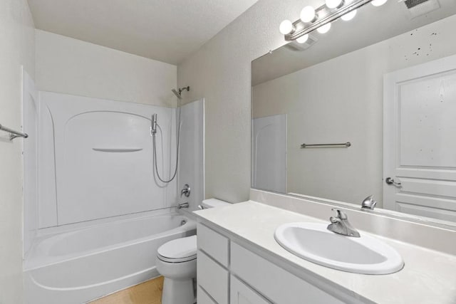 full bathroom featuring vanity, toilet, shower / bath combination, and a textured ceiling