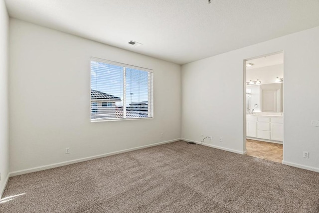 unfurnished room featuring light carpet