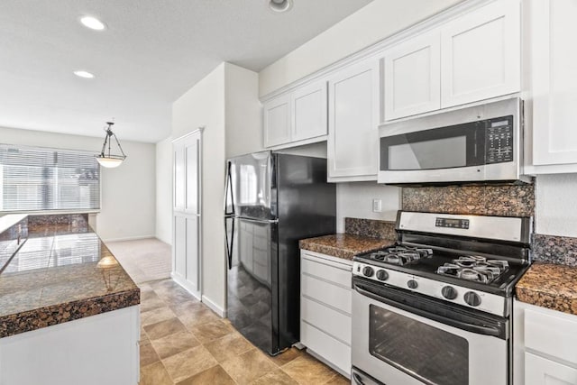 kitchen with stainless steel appliances, white cabinets, backsplash, and decorative light fixtures