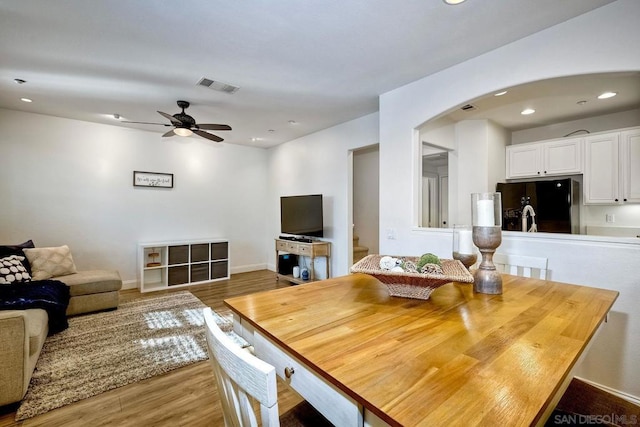 dining room with hardwood / wood-style flooring and ceiling fan