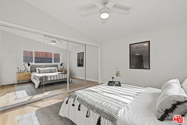 bedroom featuring lofted ceiling, ceiling fan, a closet, and wood-type flooring