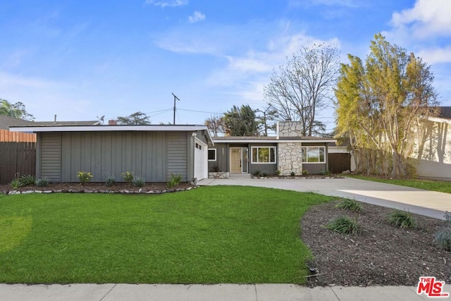 single story home featuring a front lawn and a garage