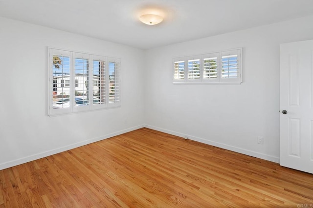 empty room featuring plenty of natural light and light hardwood / wood-style floors