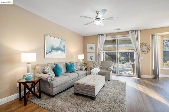 living room with wood-type flooring and ceiling fan