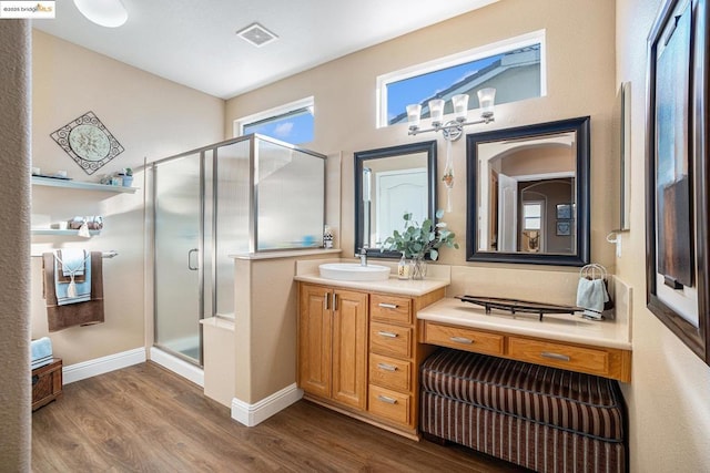 bathroom with an enclosed shower, vanity, and hardwood / wood-style floors