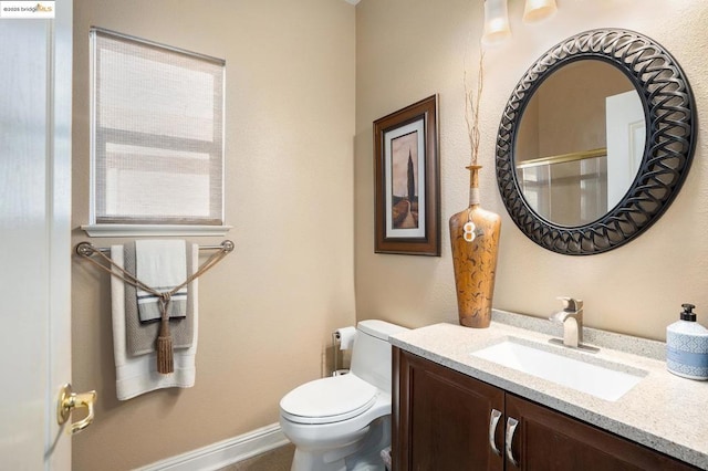 bathroom with toilet and vanity