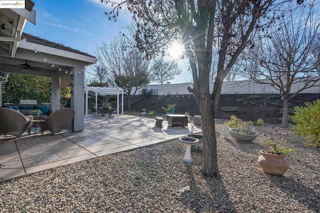 view of yard with ceiling fan, a pergola, an outdoor hangout area, and a patio