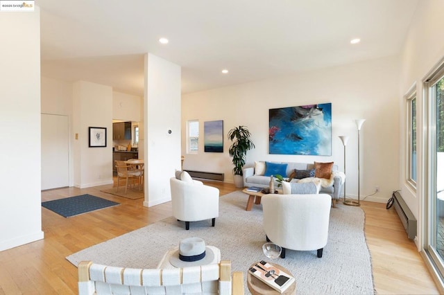 living room featuring baseboard heating and light hardwood / wood-style floors