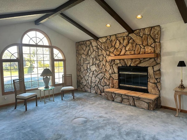 living area with carpet floors, a fireplace, lofted ceiling with beams, and a textured ceiling