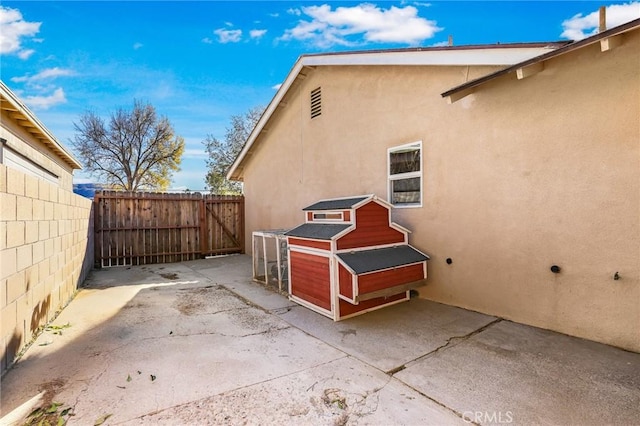 view of side of home featuring a patio area