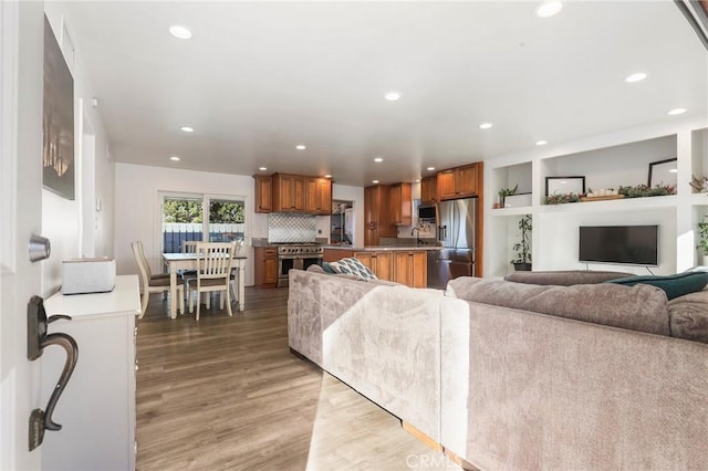 living room featuring hardwood / wood-style flooring and built in features