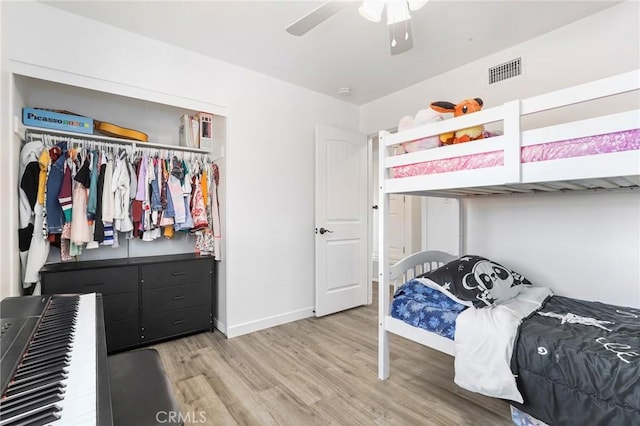 bedroom with ceiling fan, hardwood / wood-style floors, and a closet