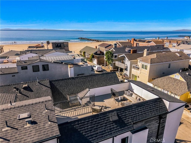 drone / aerial view featuring a water view and a view of the beach