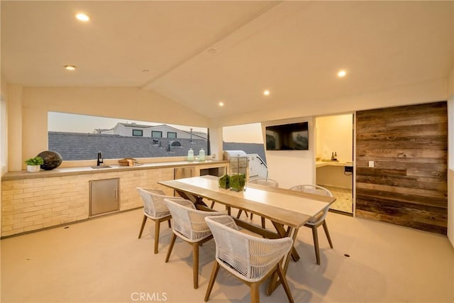 dining space with lofted ceiling and sink