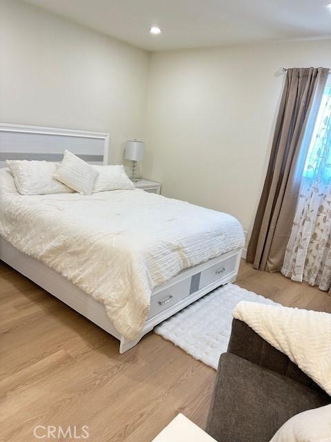 bedroom with light wood-type flooring