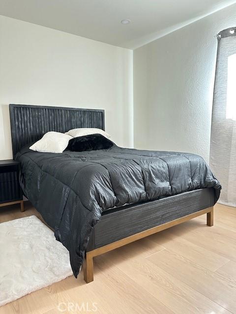 bedroom with hardwood / wood-style floors