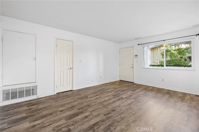 empty room with dark wood-type flooring