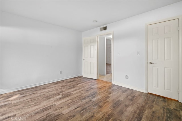 empty room with dark hardwood / wood-style floors