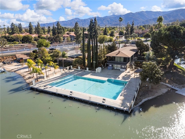 drone / aerial view featuring a water and mountain view