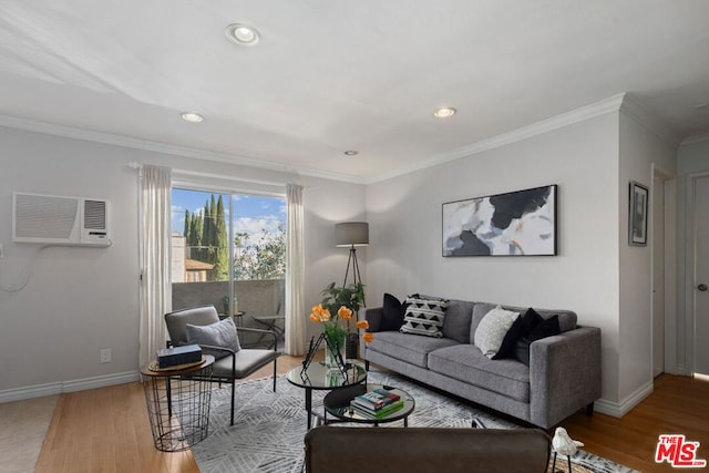 living room featuring a wall unit AC, hardwood / wood-style floors, and ornamental molding