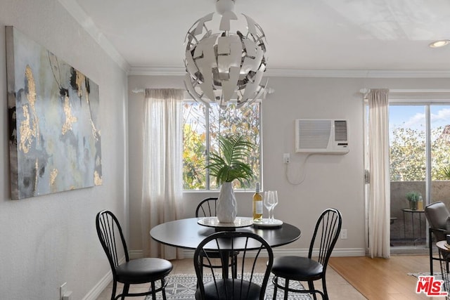 dining space featuring wood-type flooring, ornamental molding, a wall mounted air conditioner, and a chandelier