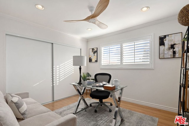 office space featuring ceiling fan, light hardwood / wood-style floors, and crown molding