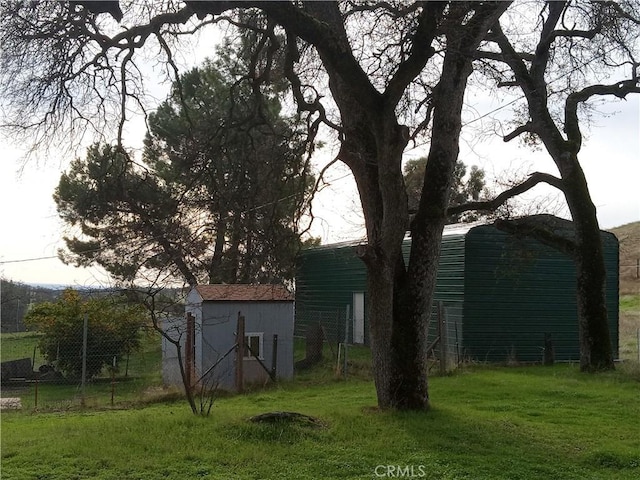 exterior space featuring a yard and an outbuilding