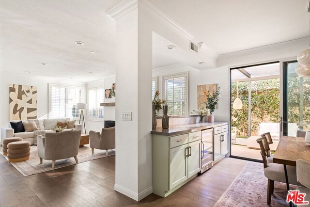 kitchen with wine cooler, light hardwood / wood-style floors, and a healthy amount of sunlight