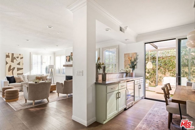 kitchen featuring a wealth of natural light, beverage cooler, and light hardwood / wood-style flooring