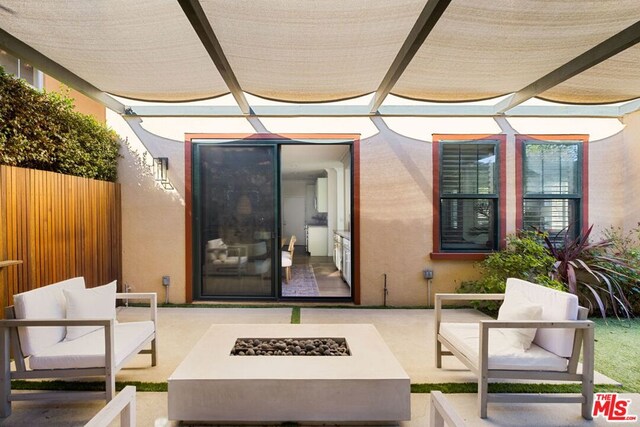 view of patio / terrace with an outdoor living space with a fire pit