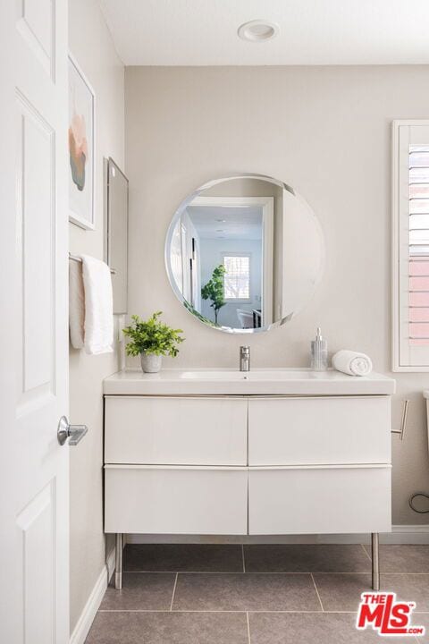 bathroom with tile patterned floors and vanity