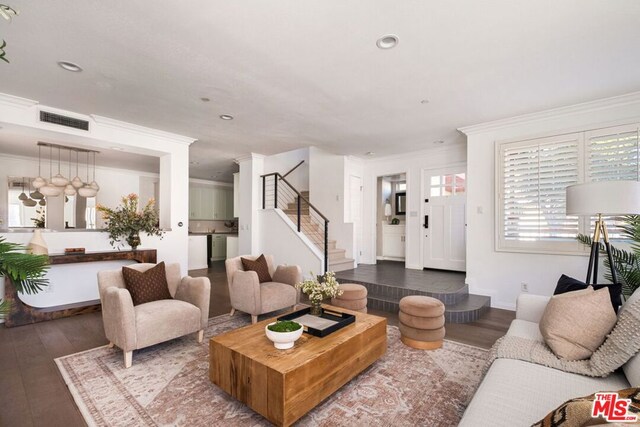 living room featuring crown molding and dark hardwood / wood-style floors