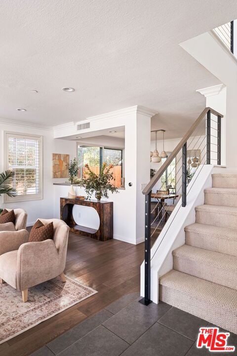 interior space with dark hardwood / wood-style flooring and crown molding