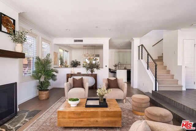 living room with crown molding and wood-type flooring