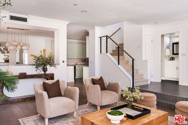 living room with ornamental molding and dark hardwood / wood-style floors