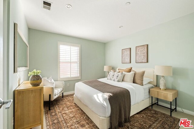 bedroom featuring dark carpet