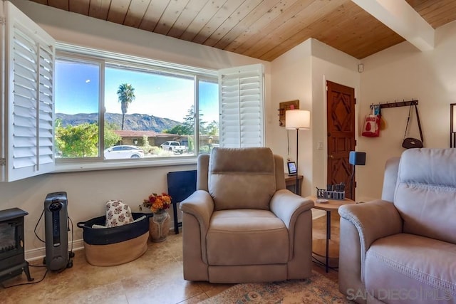 sitting room with wood ceiling, beam ceiling, light tile patterned flooring, and a mountain view